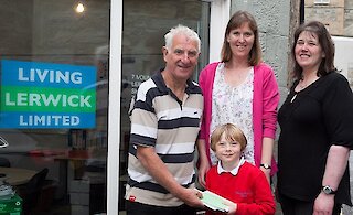 Photo by Ben Mullay, from left to right: Harry Jamieson (Living Lerwick Chair), Joanne Holden, Karsten Holden and Christena Irvine (Living Lerwick Manager).